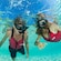 A man and a woman in snorkel gear swimming under the water’s surface